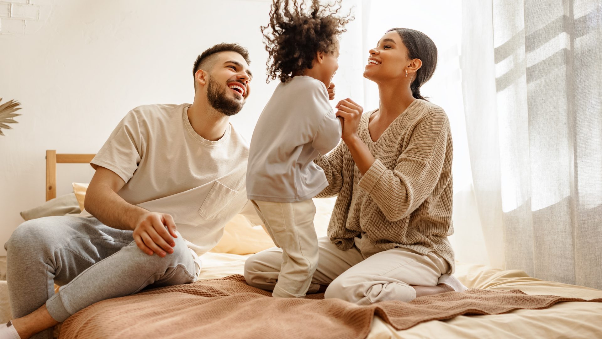 a family is sitting on a bed together at The Soltera Rolling Pines